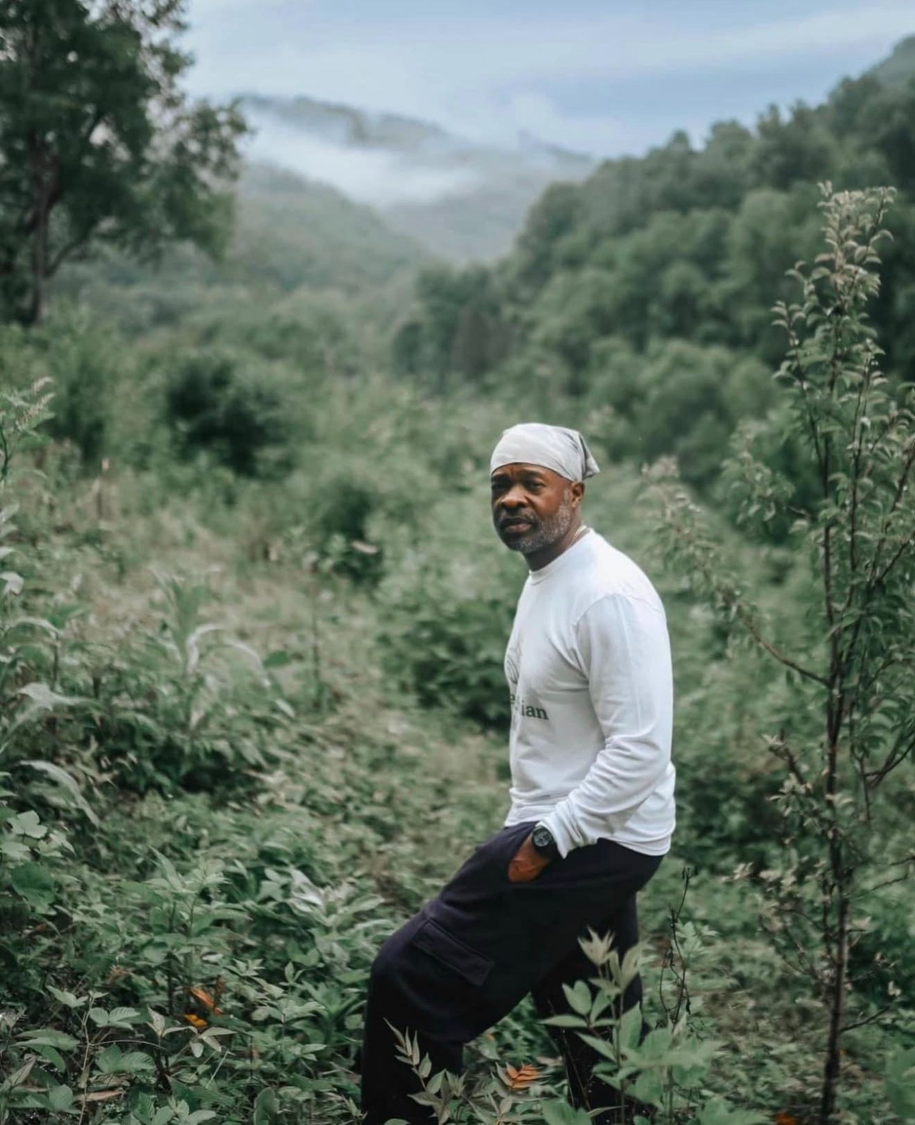Jason Tartt, Sr. standing in green growth on a misty Appalachian hillside.